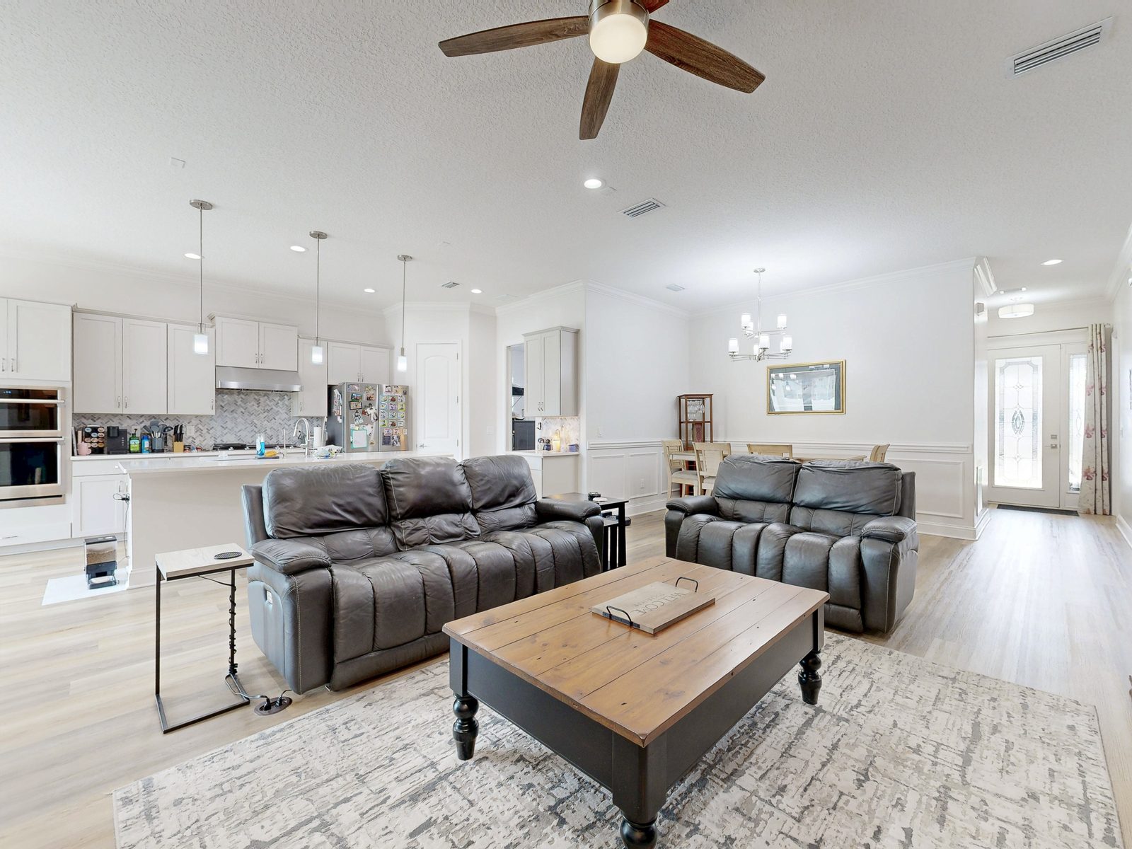 Bright HDR photo of an open-concept living room and kitchen in a Jacksonville FL home, exported from a Matterport 3D scan