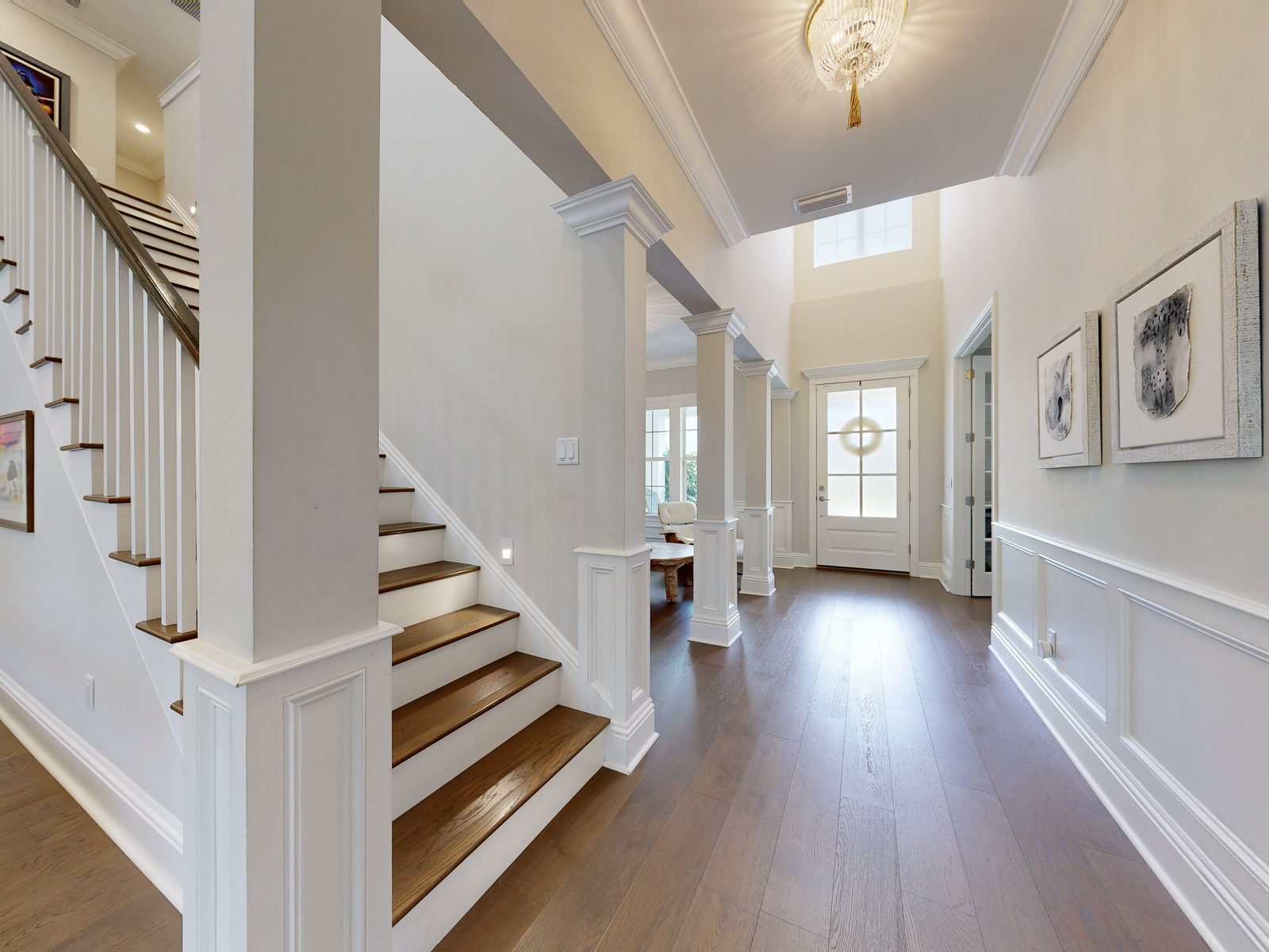 HDR photo of a bright entry foyer with wood staircase exported from a Matterport 3D scan, Ponte Vedra Beach FL real estate photography