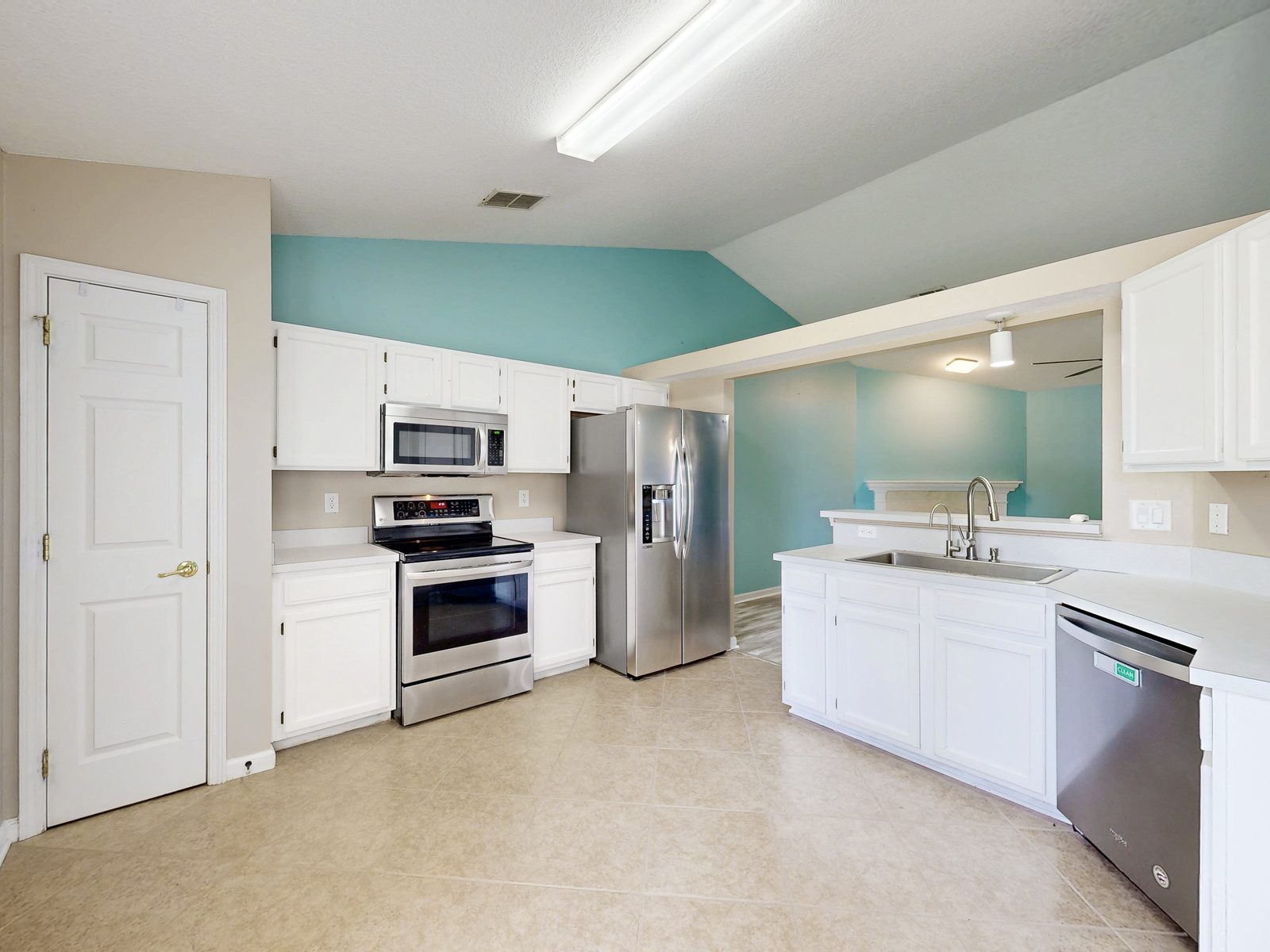 HDR listing photo of a white kitchen with stainless appliances from a Matterport 3D scan, Jacksonville area real estate photography